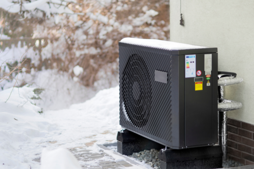 Heat Pump on side of house in winter