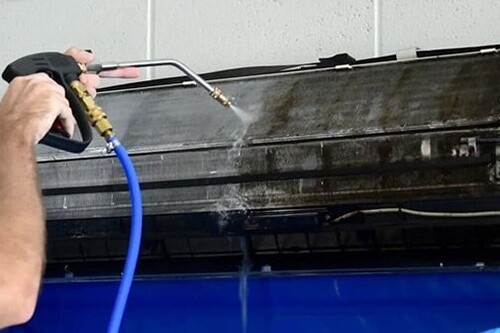 A ductless unit being cleaned