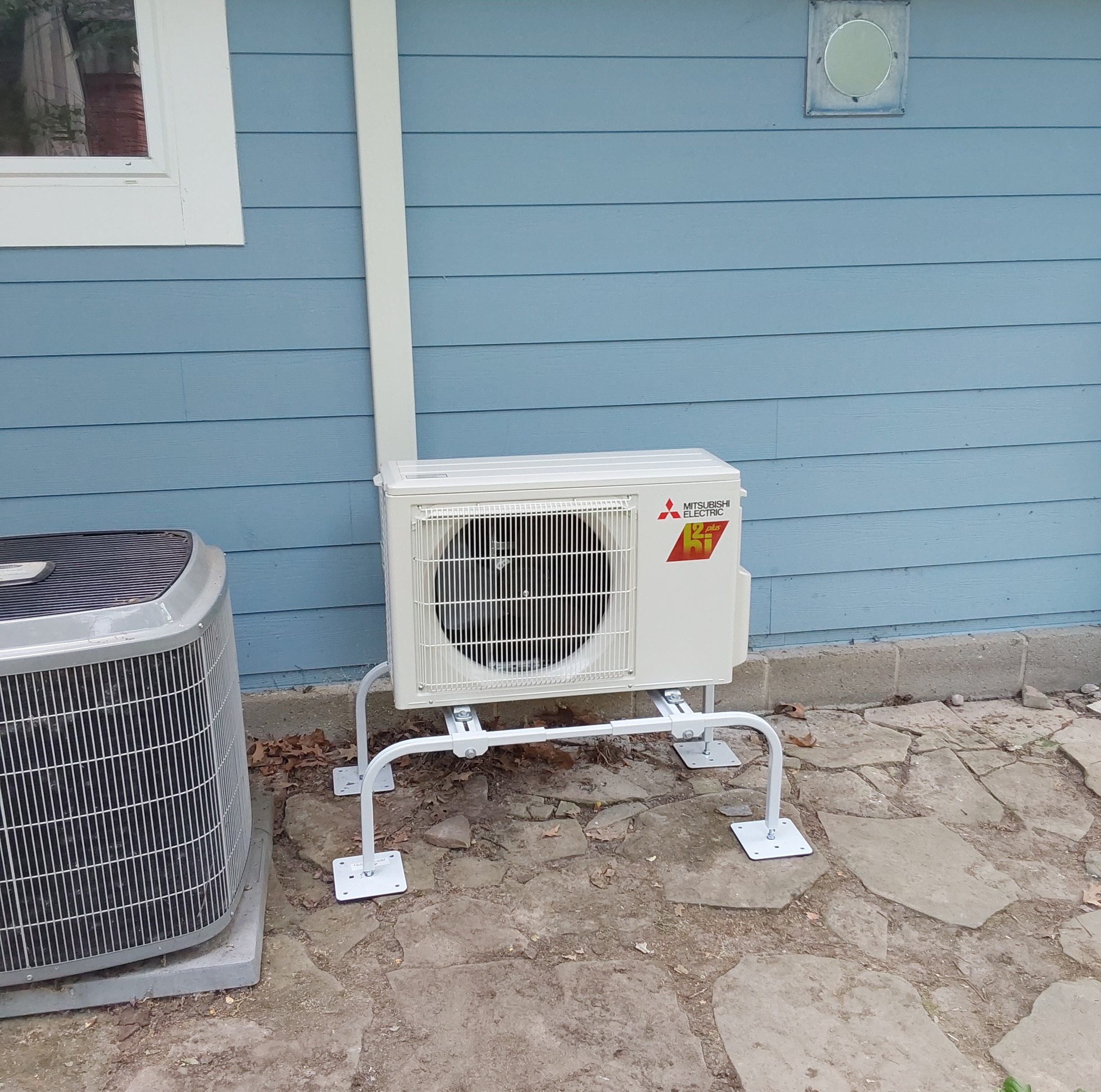 Mitsubishi Heat Pump Ann Arbor along a blue house