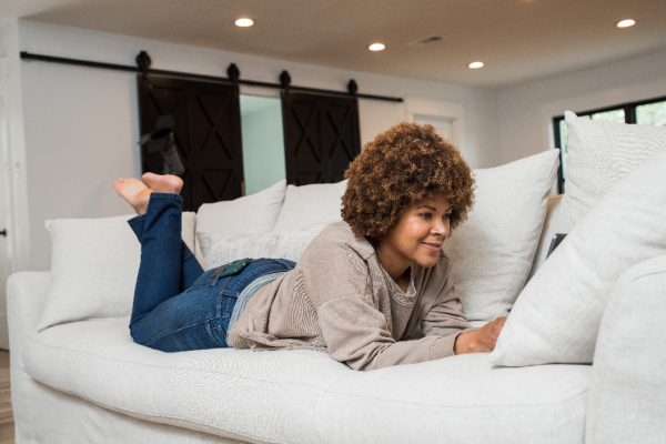 Individual laying on a couch in a home services by CMR Mechanical.