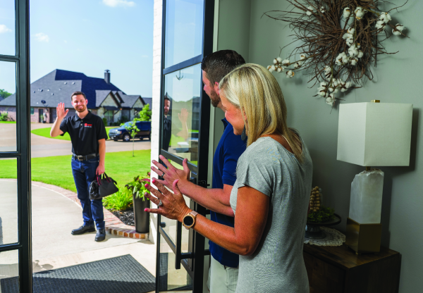 CMR Mechanical technician waving to customers.