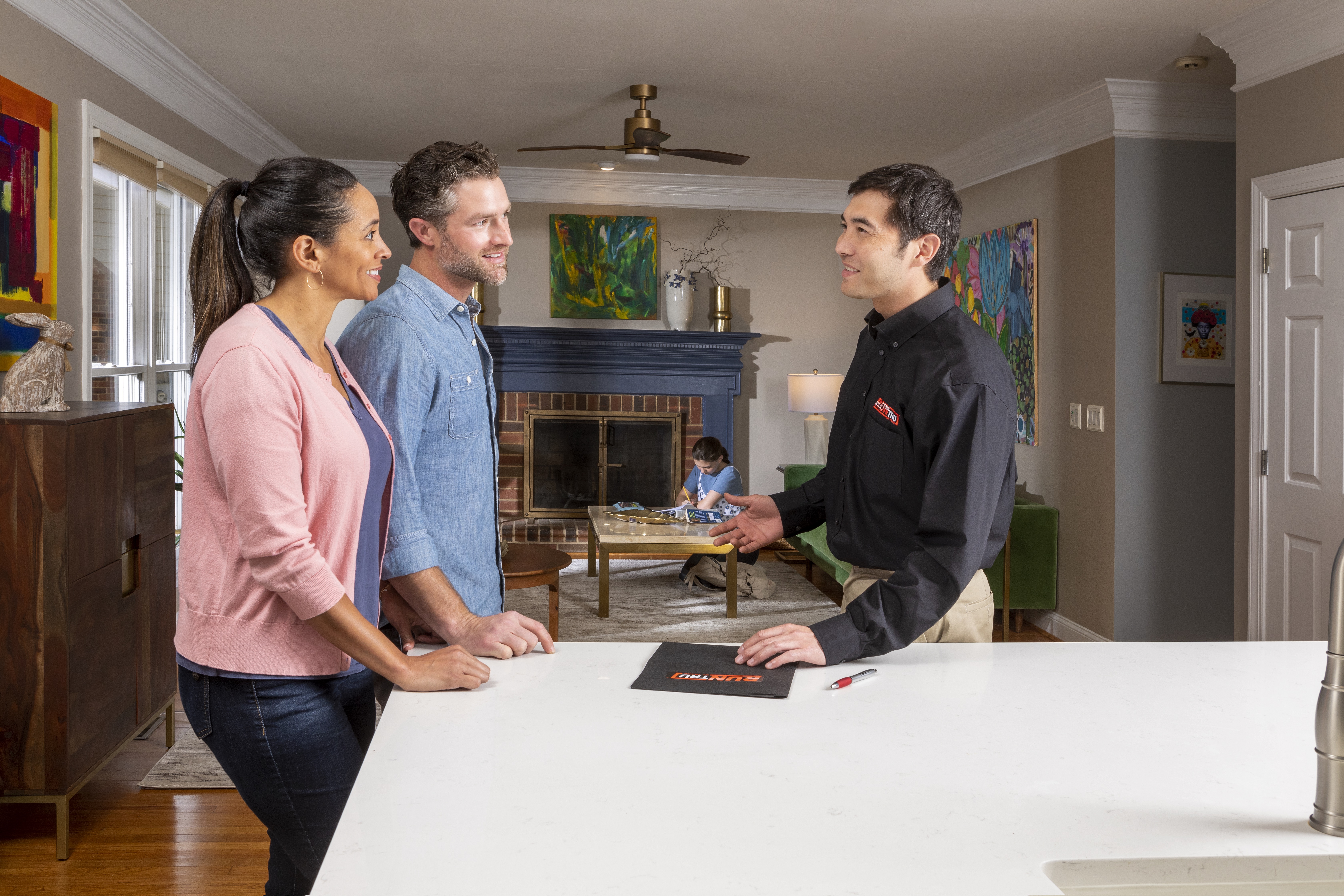 Individuals speaking in the kitchen of a home serviced by CMR Mechanical.